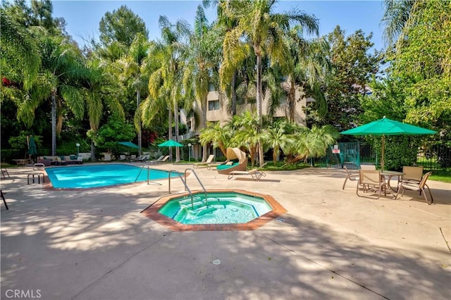 4200 Via Arbolada Unit 123, Los Angeles, CA 90042 - community pool with a patio area, a community hot tub, fence, and view of scattered trees