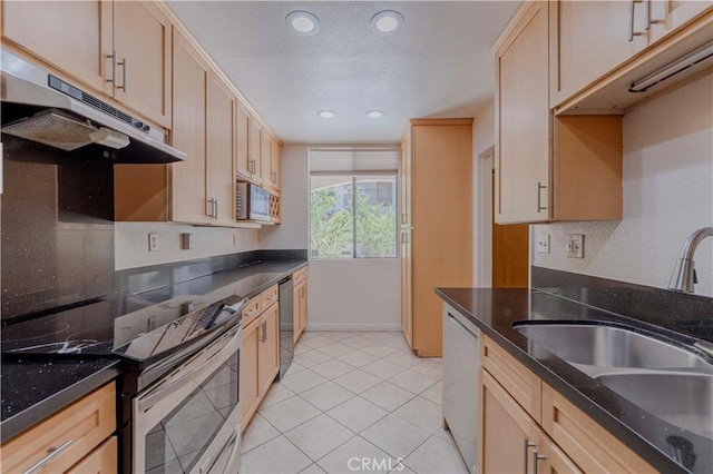 4200 Via Arbolada Unit 123, Los Angeles, CA 90042 - kitchen with appliances with stainless steel finishes, a sink, light brown cabinets, recessed lighting, and light tile patterned floors