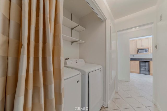 4200 Via Arbolada Unit 123, Los Angeles, CA 90042 - laundry area with beverage cooler, washer and dryer, and light tile patterned floors