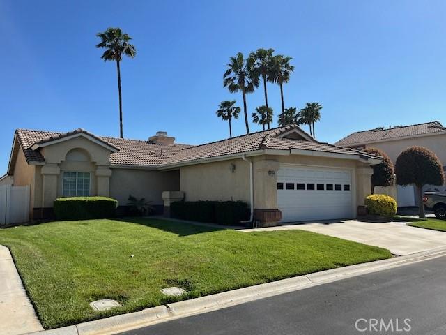 3060 Summer Set Cir, Banning, CA 92220 - single story home with a garage, a tile roof, stucco siding, concrete driveway, and a chimney