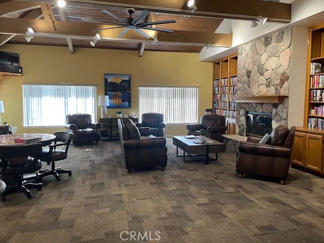 3060 Summer Set Cir, Banning, CA 92220 - carpeted living area featuring a fireplace and beam ceiling