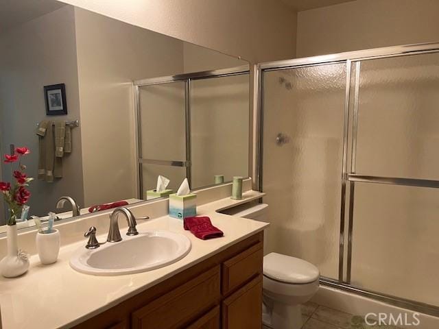 3060 Summer Set Cir, Banning, CA 92220 - full bath featuring an enclosed shower, vanity, toilet, and tile patterned floors