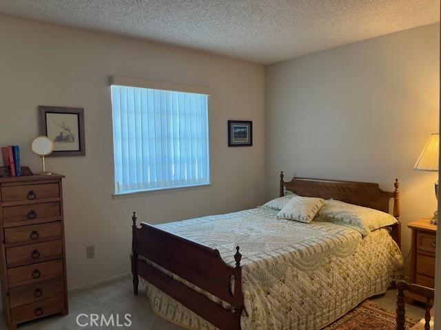 3060 Summer Set Cir, Banning, CA 92220 - bedroom with a textured ceiling and light colored carpet
