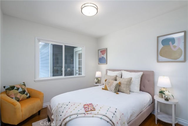 bedroom with wood finished floors and baseboards