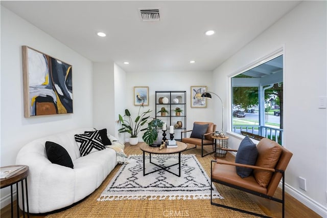 living area featuring wood finished floors and recessed lighting