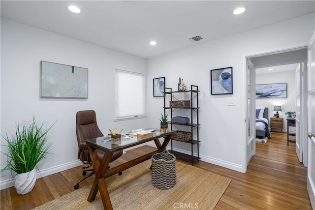 office space with wood finished floors, baseboards, and recessed lighting