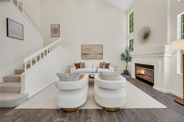 13385 Savanna, Tustin, CA 92782 - living area with high vaulted ceiling, stairs, a glass covered fireplace, wood finished floors, and baseboards