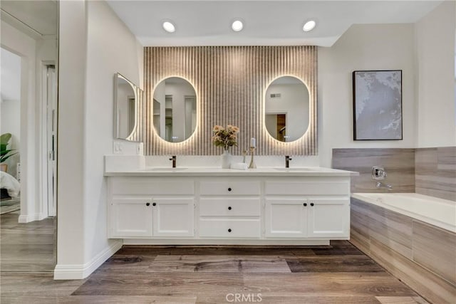 13385 Savanna, Tustin, CA 92782 - bathroom with a bath, double vanity, recessed lighting, wood finished floors, and baseboards
