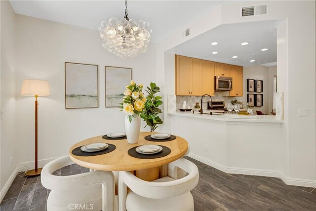 13385 Savanna, Tustin, CA 92782 - dining space with a chandelier, dark wood-style floors, baseboards, and recessed lighting