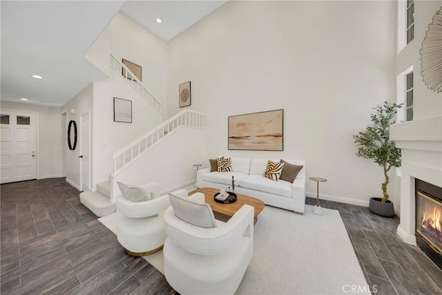 13385 Savanna, Tustin, CA 92782 - living room with wood finished floors, baseboards, a towering ceiling, recessed lighting, and a glass covered fireplace