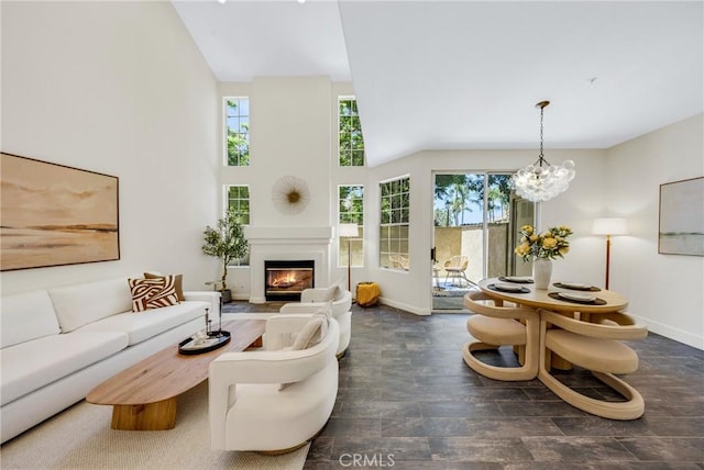13385 Savanna, Tustin, CA 92782 - living area with a fireplace with flush hearth, baseboards, a chandelier, and high vaulted ceiling