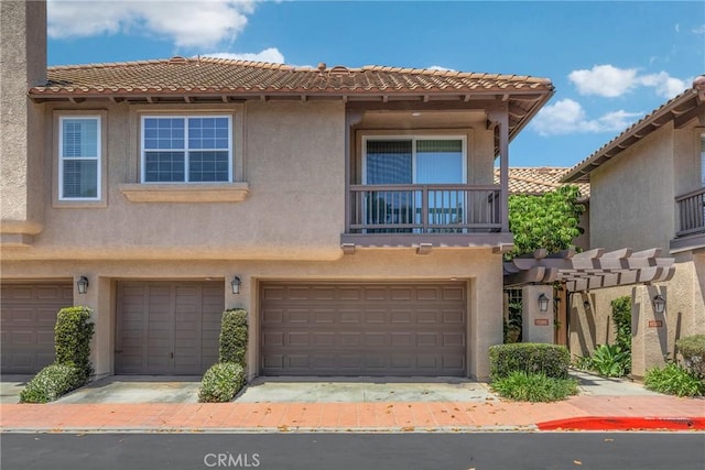 13385 Savanna, Tustin, CA 92782 - townhome / multi-family property featuring an attached garage, stucco siding, a tiled roof, and a balcony