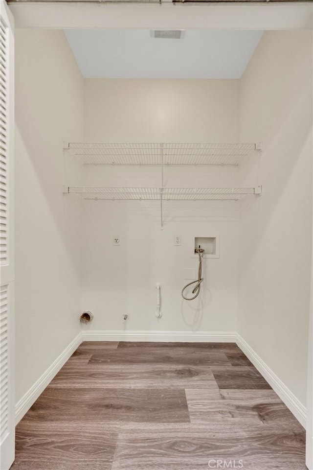 13385 Savanna, Tustin, CA 92782 - clothes washing area with hookup for a gas dryer, wood finished floors, electric dryer hookup, washer hookup, and baseboards