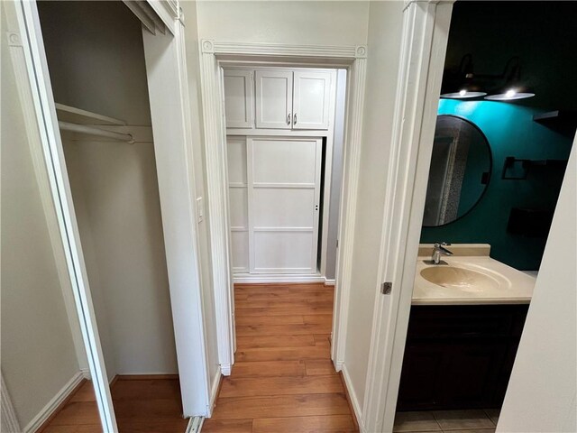 136 S Fircroft St, West Covina, CA 91791 - bathroom featuring wood finished floors, vanity, and baseboards