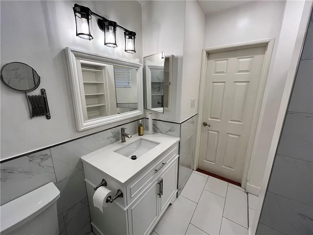 136 S Fircroft St, West Covina, CA 91791 - bathroom with tile walls, vanity, toilet, and wainscoting