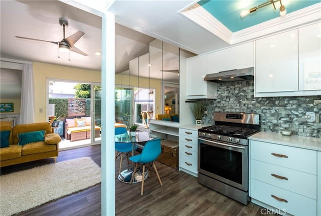 17072 Pacific Coast Unit 202, Huntington Beach, CA 92649 - kitchen featuring gas range, exhaust hood, decorative backsplash, a ceiling fan, and white cabinets