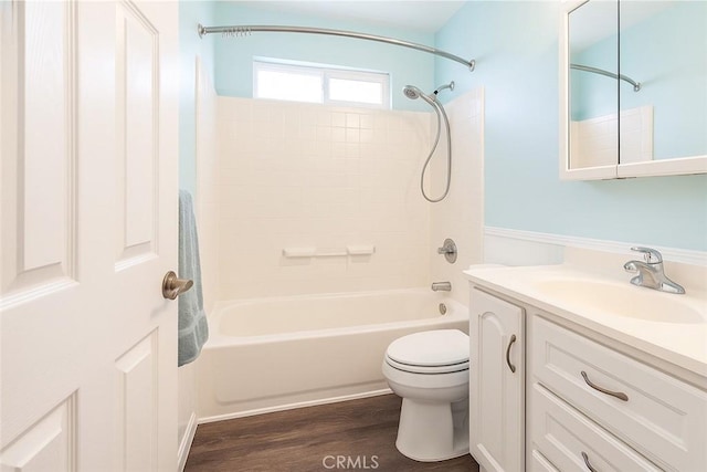 full bath featuring shower / bath combination, wood finished floors, vanity, and toilet