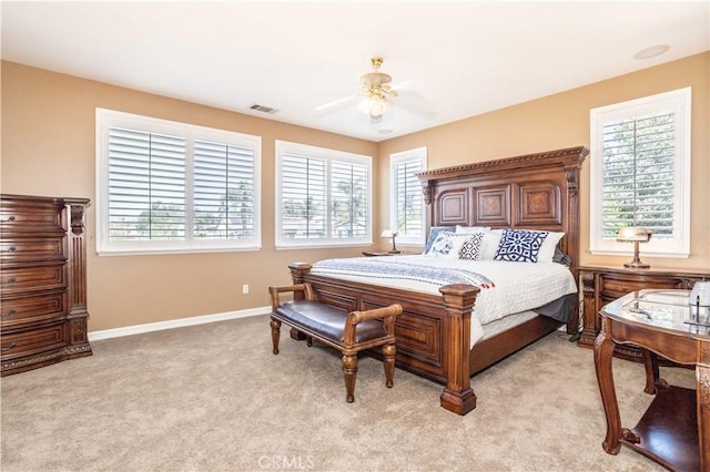 bedroom with light colored carpet, baseboards, and ceiling fan