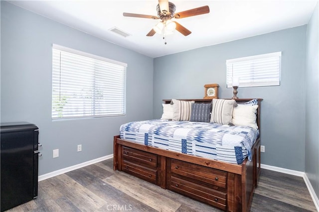 bedroom featuring wood finished floors, baseboards, and ceiling fan