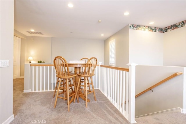 carpeted dining space with recessed lighting and baseboards