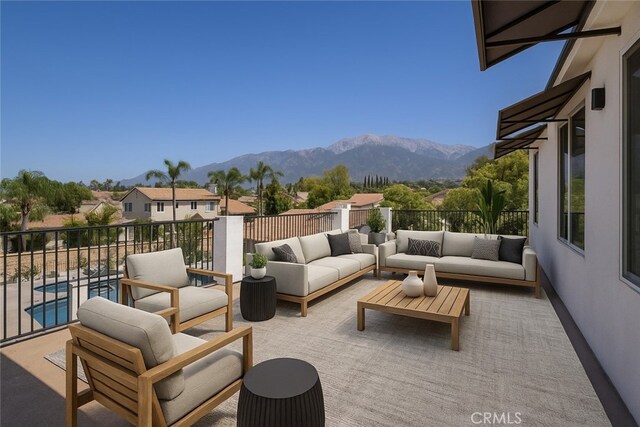 view of patio with an outdoor hangout area, a mountain view, and a balcony