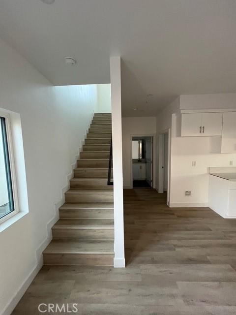 1217 E 22nd St, Los Angeles, CA 90011 - staircase with wood finished floors and baseboards