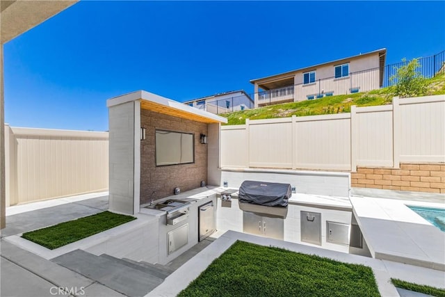 view of patio / terrace featuring area for grilling and a fenced backyard