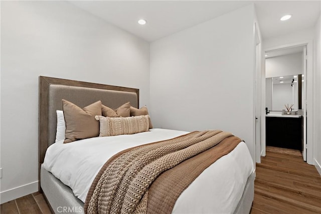 bedroom featuring dark wood-style flooring, recessed lighting, and baseboards
