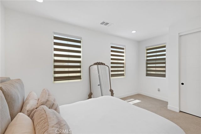 bedroom with carpet, baseboards, recessed lighting, and a closet
