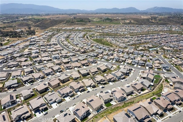 aerial view of property's location featuring mountains and nearby suburban area