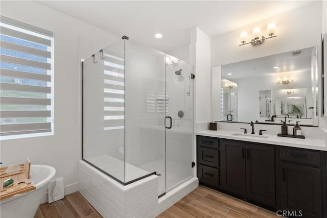 39494 Sagewood Rdg, Temecula, CA 92591 - bathroom featuring wood tiled floors, vanity, a freestanding tub, a stall shower, and recessed lighting