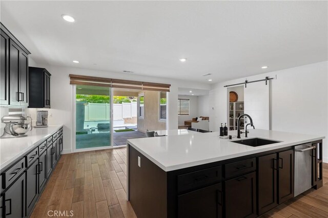 39494 Sagewood Rdg, Temecula, CA 92591 - kitchen featuring a sink, light wood finished floors, a center island with sink, light countertops, and recessed lighting
