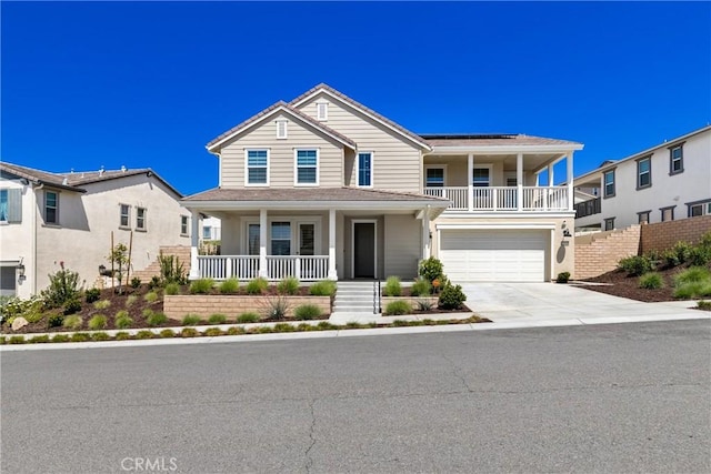 view of front of house featuring a porch, driveway, and a garage
