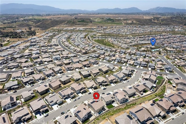 aerial overview of property's location featuring a mountain backdrop and nearby suburban area