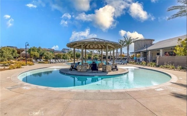 community pool featuring a gazebo and a patio area