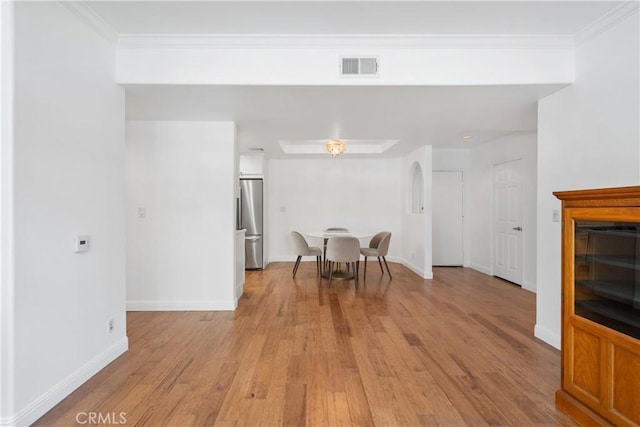 4230 Colfax Ave Unit 103, Studio City, CA 91604 - dining room featuring light wood-style floors, baseboards, crown molding, and arched walkways