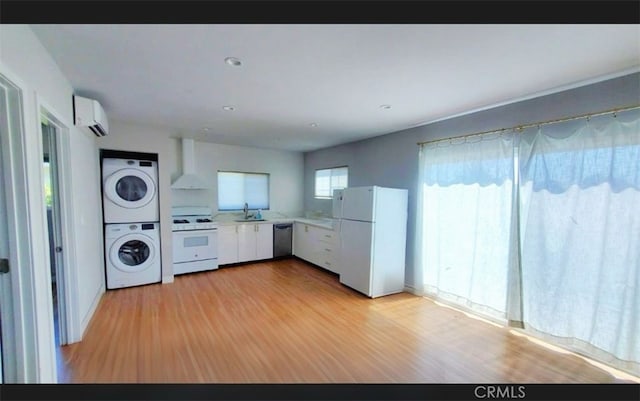 606608 Fairview Ave, Los Angeles, CA 90033 - washroom with stacked washing machine and dryer, light wood-style floors, and an AC wall unit