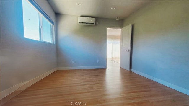 606608 Fairview Ave, Los Angeles, CA 90033 - spare room with a wall mounted AC, light wood-style floors, and baseboards