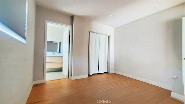 606608 Fairview Ave, Los Angeles, CA 90033 - unfurnished bedroom featuring wood finished floors, baseboards, and a closet