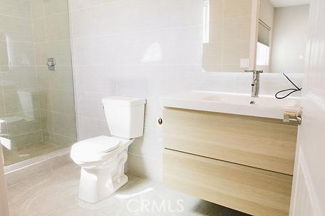 606608 Fairview Ave, Los Angeles, CA 90033 - bathroom with toilet, tiled shower, tile walls, and vanity