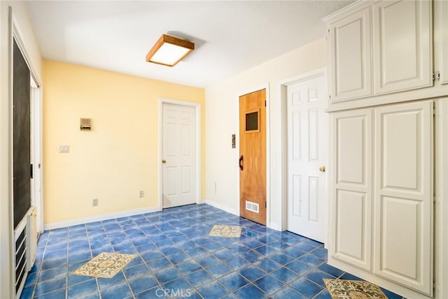 321 13th St, Huntington Beach, CA 92648 - foyer entrance with dark tile patterned flooring and baseboards