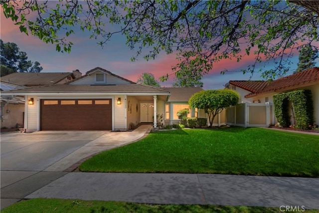 ranch-style home featuring a garage, concrete driveway, and a tile roof