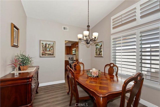 dining area featuring a chandelier, dark wood finished floors, and baseboards