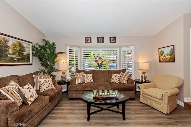 living area featuring light wood-type flooring and baseboards