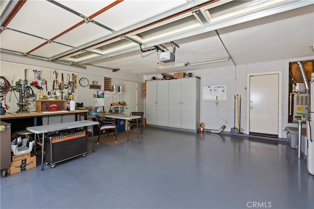 garage with a garage door opener and a workshop area