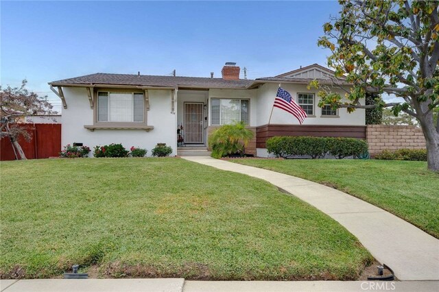 404 N San Jose Ave, Covina, CA 91723 - view of front facade featuring a chimney and stucco siding
