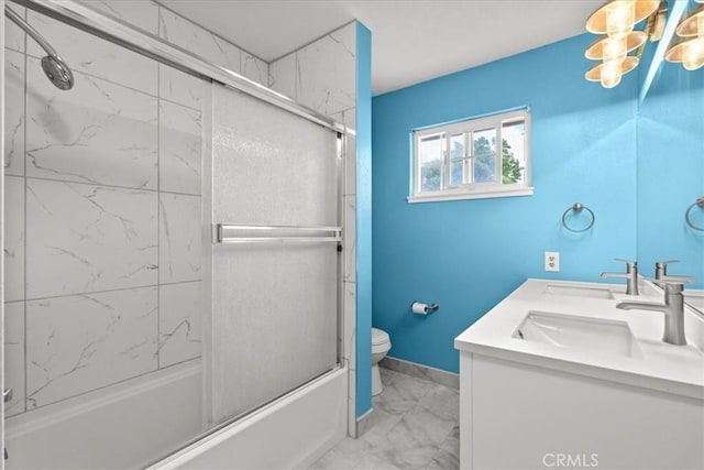 3439 De Anza Ave, Merced, CA 95348 - full bathroom with marble finish floors, toilet, double vanity, combined bath / shower with glass door, and baseboards