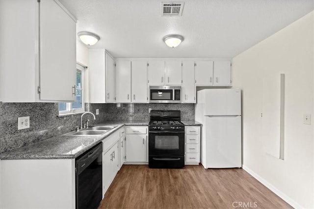 3439 De Anza Ave, Merced, CA 95348 - kitchen with black appliances, a sink, wood finished floors, white cabinetry, and decorative backsplash
