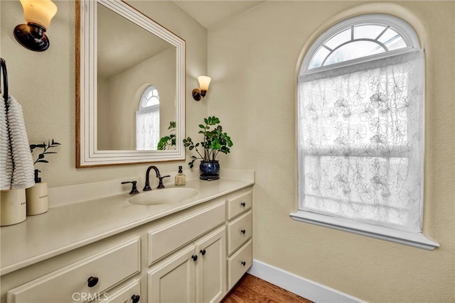 21425 Valley Oak Dr, Middletown, CA 95461 - bathroom featuring plenty of natural light, vanity, wood finished floors, and baseboards