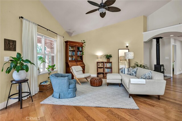 21425 Valley Oak Dr, Middletown, CA 95461 - living area featuring high vaulted ceiling, ceiling fan, wood finished floors, a wood stove, and baseboards